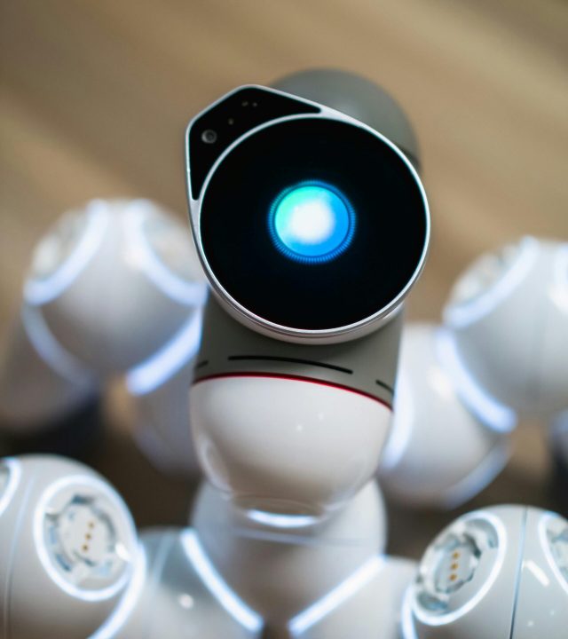 Close-up view of a humanoid robot with a glowing blue eye, symbolizing advanced technology.